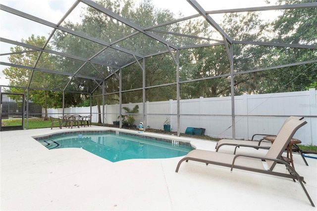 view of swimming pool featuring a lanai and a patio area