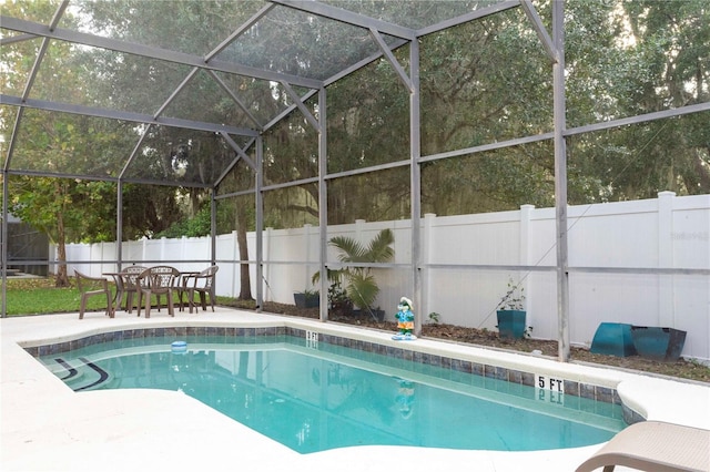 view of swimming pool with a patio and a lanai