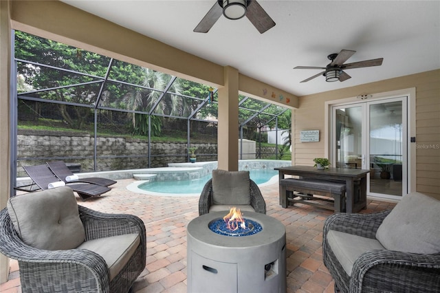 view of patio / terrace with glass enclosure, ceiling fan, and a pool with hot tub