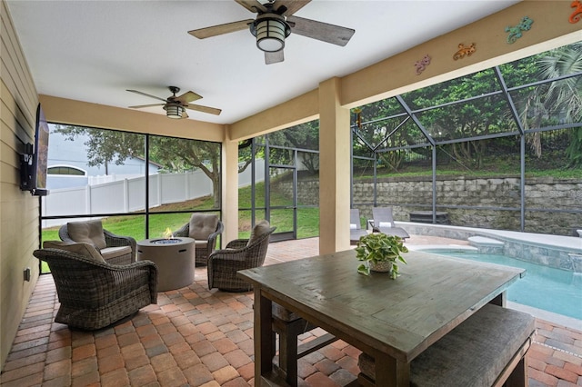 sunroom / solarium with a swimming pool, ceiling fan, and plenty of natural light