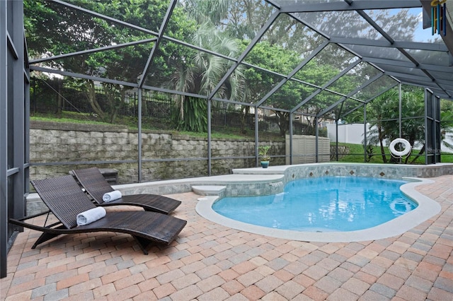 view of pool featuring a lanai, a hot tub, and a patio area