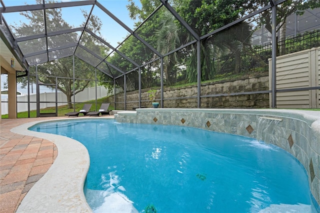 view of pool featuring pool water feature, a lanai, and a patio area