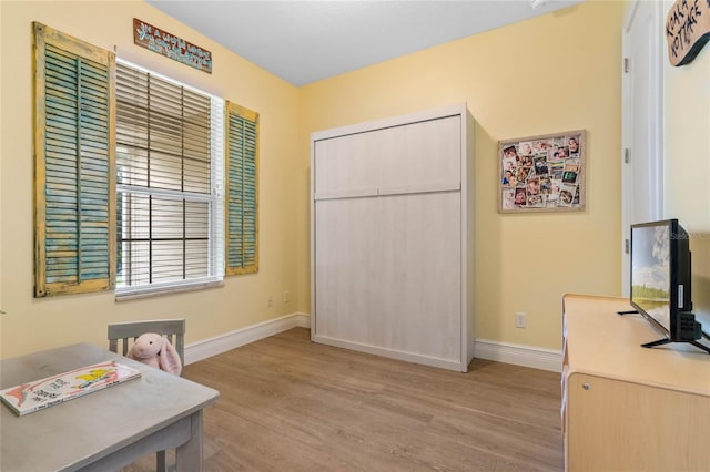 home office with light hardwood / wood-style floors