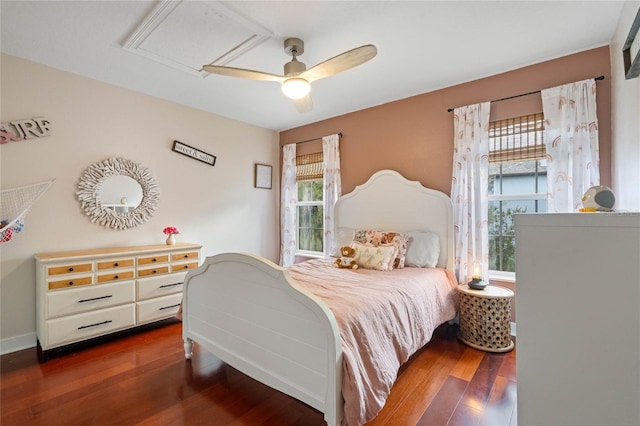 bedroom with dark hardwood / wood-style floors and ceiling fan