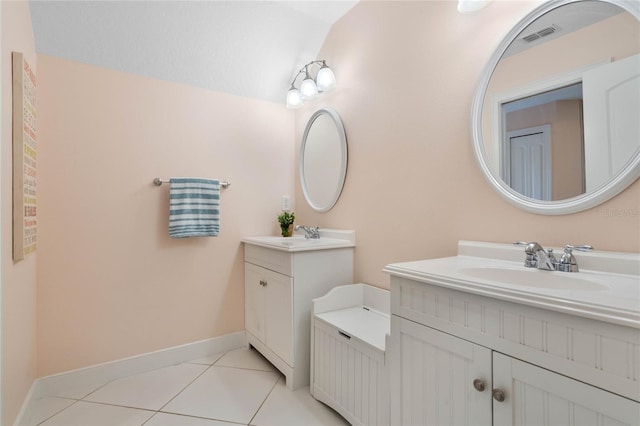 bathroom with vanity, lofted ceiling, and tile patterned floors