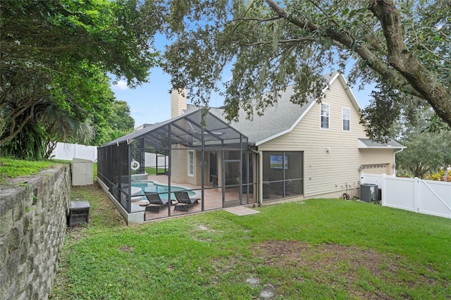 back of property with a lanai, a patio, a fenced in pool, central AC, and a yard