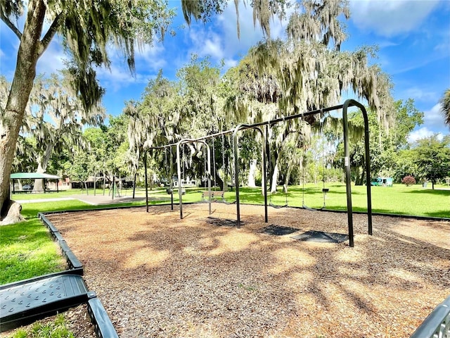 view of home's community with a lawn and a playground