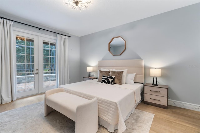 bedroom with access to exterior, baseboards, light wood-style floors, and french doors