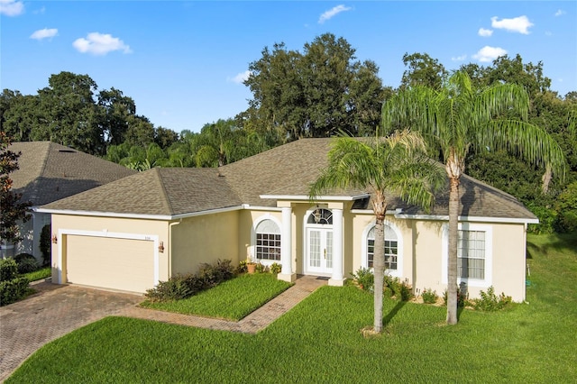 ranch-style home featuring a front yard and a garage