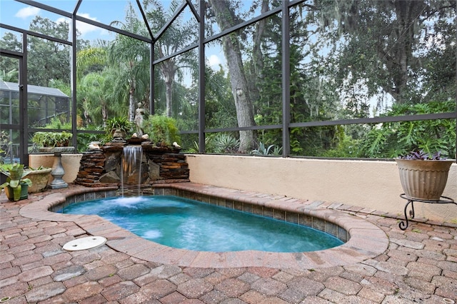 view of swimming pool featuring a lanai