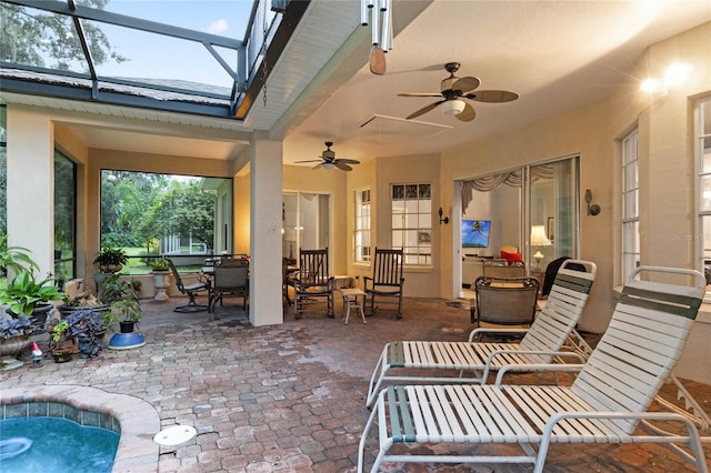 view of patio / terrace featuring glass enclosure and ceiling fan