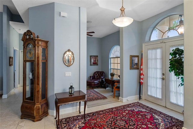 foyer featuring french doors, plenty of natural light, and light tile patterned floors