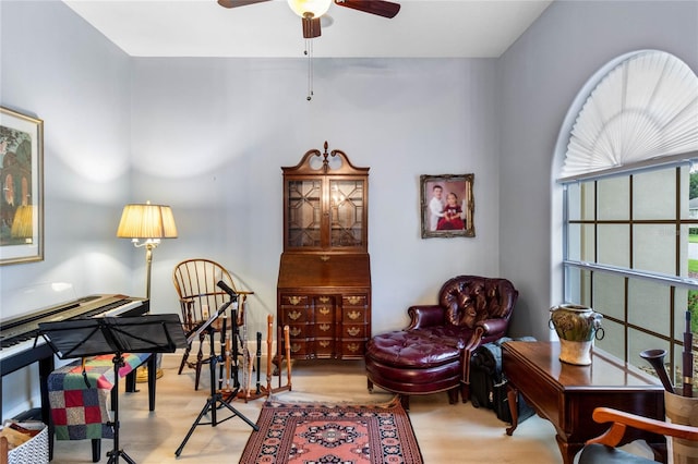 living area with light wood-type flooring and ceiling fan