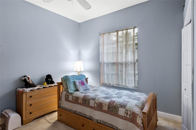 bedroom with light carpet, a closet, and ceiling fan