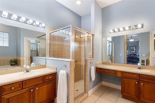 bathroom with vanity, shower with separate bathtub, ceiling fan, and tile patterned floors