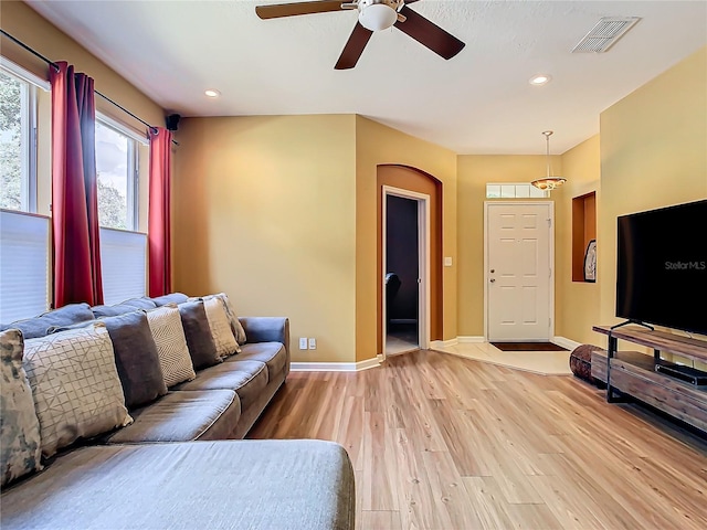 living room featuring ceiling fan and light wood-type flooring