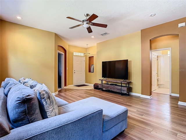 living room featuring ceiling fan and hardwood / wood-style flooring