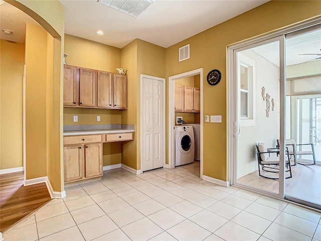 kitchen with built in desk, washer / clothes dryer, light brown cabinetry, ceiling fan, and light hardwood / wood-style flooring