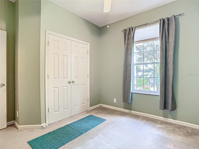 bedroom with a closet, ceiling fan, and carpet flooring