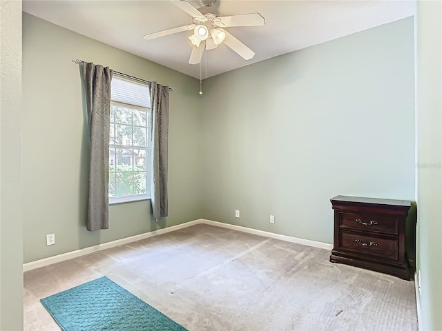 spare room featuring ceiling fan and light colored carpet