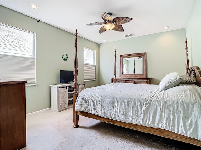 bedroom with ceiling fan and light carpet