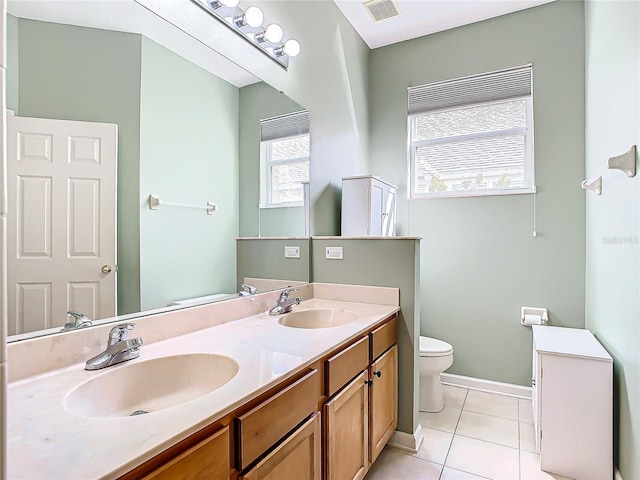 bathroom featuring vanity, toilet, and tile patterned floors