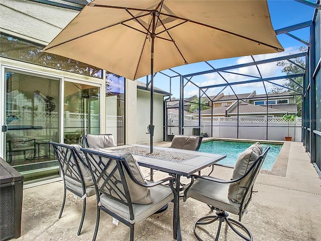 view of patio featuring a fenced in pool and glass enclosure