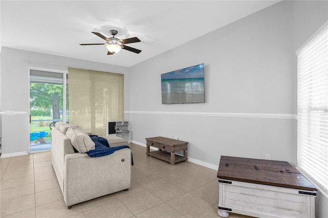 living room with ceiling fan and light tile patterned flooring