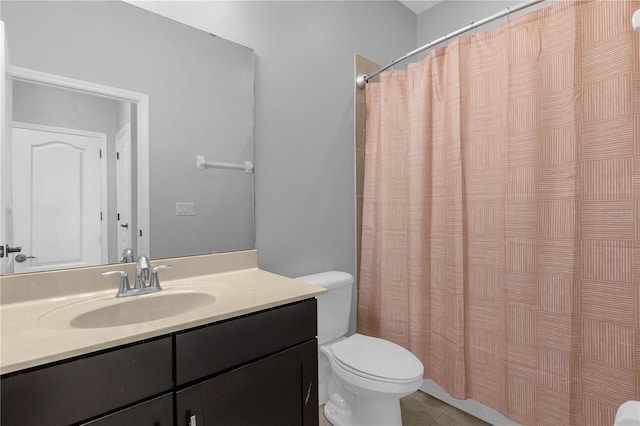 bathroom with a shower with curtain, vanity, tile patterned flooring, and toilet