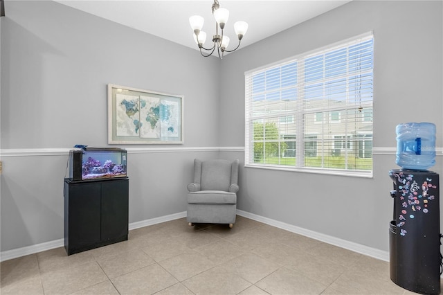 sitting room featuring an inviting chandelier and light tile patterned floors