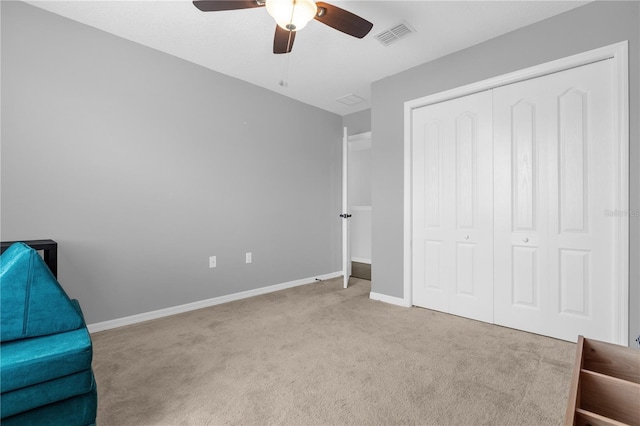 unfurnished room with ceiling fan and light colored carpet