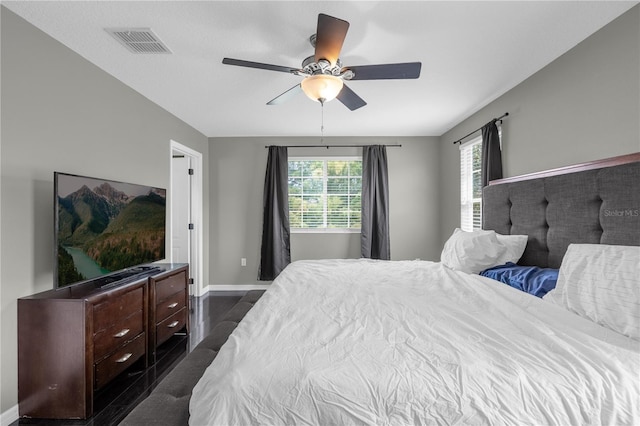 bedroom featuring ceiling fan and dark hardwood / wood-style flooring