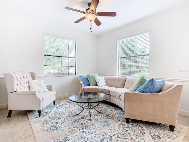 living room with light tile patterned flooring, ceiling fan, and a wealth of natural light