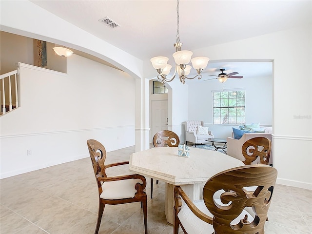 8920 Dove Valley Way, Davenport, FL 33896 - dining room with arched walkways, a chandelier, light tile patterned floors, and baseboards