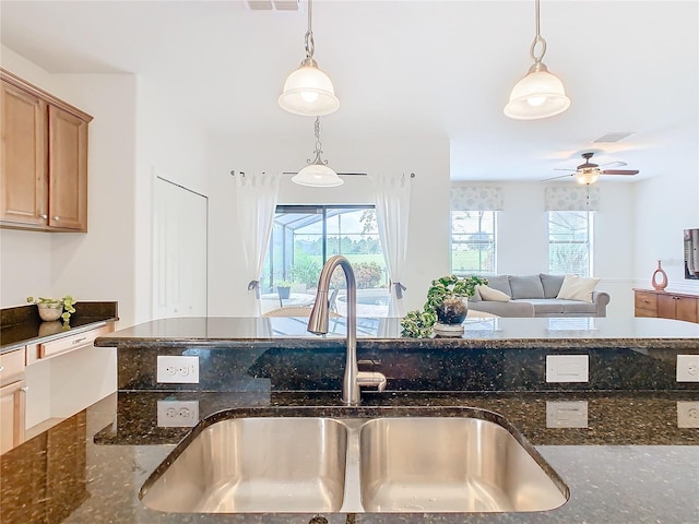 8920 Dove Valley Way, Davenport, FL 33896 - kitchen featuring a sink, hanging light fixtures, dark stone counters, and ceiling fan