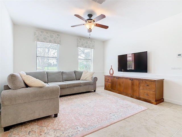 8920 Dove Valley Way, Davenport, FL 33896 - living room featuring ceiling fan, light tile patterned flooring, and baseboards
