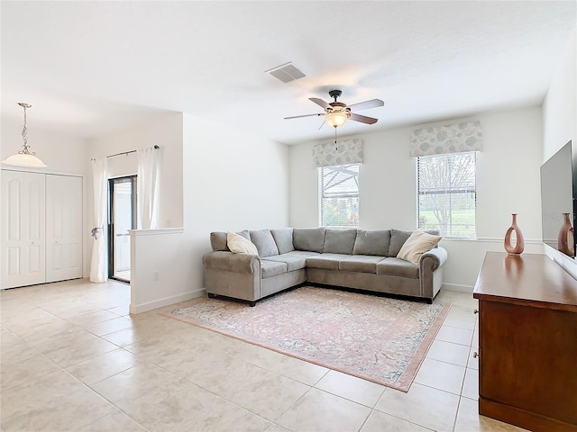 tiled living room with ceiling fan