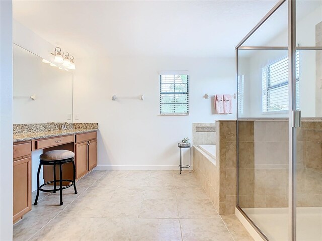 8920 Dove Valley Way, Davenport, FL 33896 - full bathroom featuring tile patterned flooring, vanity, a shower stall, a bath, and baseboards