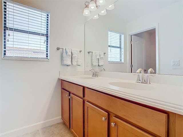 8920 Dove Valley Way, Davenport, FL 33896 - bathroom featuring baseboards, tile patterned flooring, and double vanity