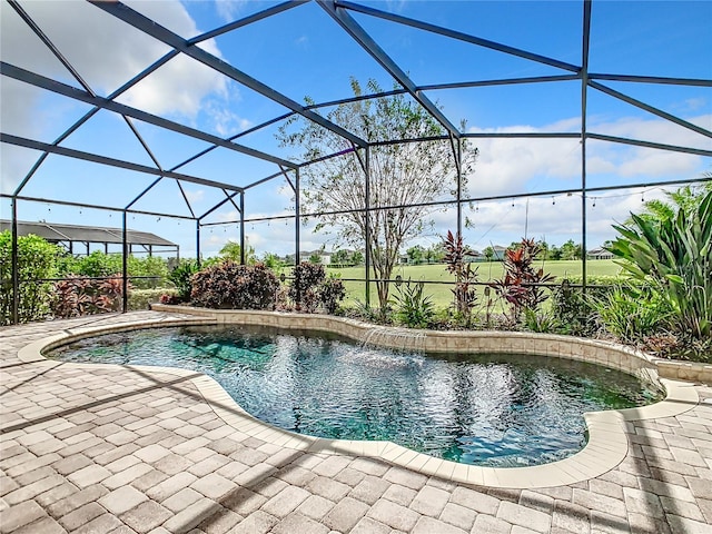 view of swimming pool featuring glass enclosure, a patio, and pool water feature