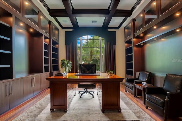 office space featuring beamed ceiling, light hardwood / wood-style floors, and coffered ceiling