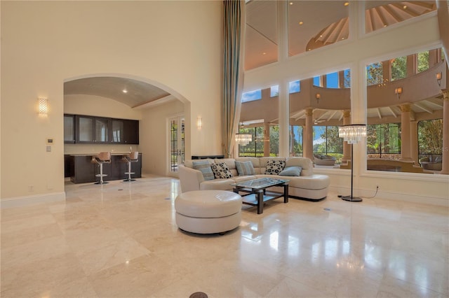 living room with high vaulted ceiling and an inviting chandelier