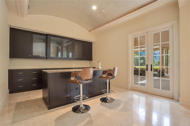 bar featuring brick ceiling, light stone counters, french doors, and vaulted ceiling