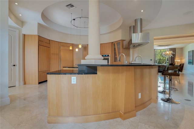 kitchen featuring a raised ceiling, stainless steel oven, a towering ceiling, and pendant lighting