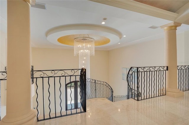 stairway featuring decorative columns, an inviting chandelier, and crown molding