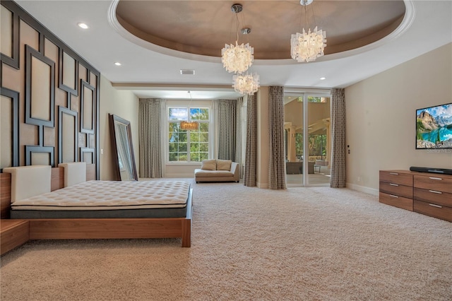 carpeted bedroom featuring an inviting chandelier, access to exterior, and a tray ceiling