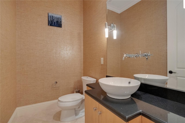 bathroom with tile patterned flooring, vanity, and toilet