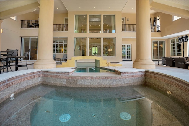 view of swimming pool featuring a hot tub