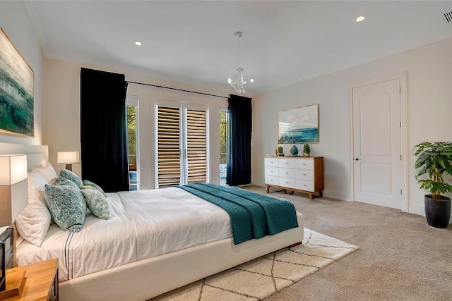 carpeted bedroom with ornamental molding and a notable chandelier