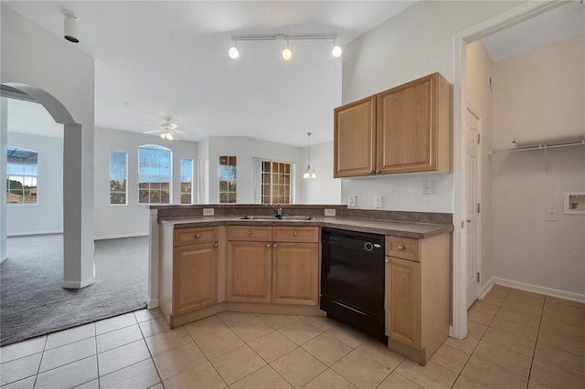 kitchen featuring black dishwasher, decorative light fixtures, light tile patterned floors, and sink